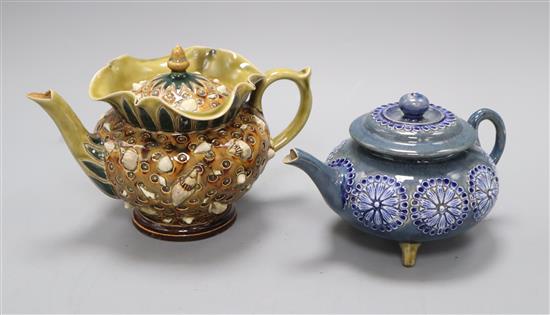 An unusual Doulton Lambeth shells teapot and cover and a flowerhead decorated tripod teapot attributed to Alice Barker 20.5 and 17.5c